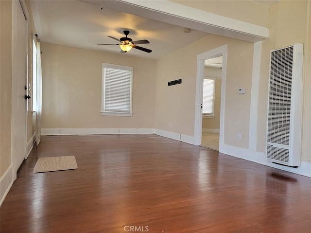 empty room featuring ceiling fan and dark hardwood / wood-style flooring