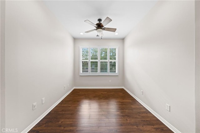 empty room with ceiling fan and dark hardwood / wood-style floors