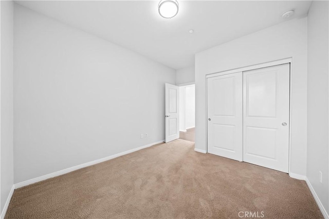 unfurnished bedroom featuring a closet and carpet floors