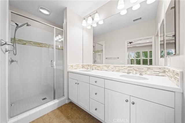 bathroom with tile patterned floors, decorative backsplash, ceiling fan, and a shower with door