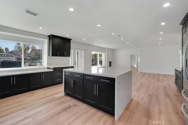 kitchen with a center island and light hardwood / wood-style flooring