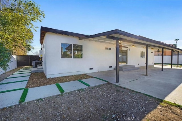 view of front of home with ceiling fan, a patio area, and central air condition unit