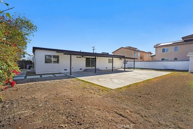 rear view of house featuring a patio area and a lawn