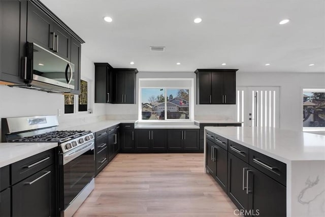 kitchen with sink, light hardwood / wood-style flooring, and stainless steel appliances