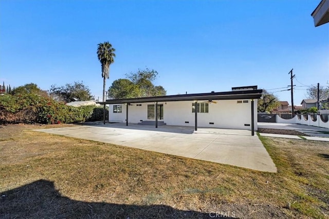 back of house with a patio area and a yard