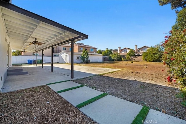 view of yard featuring ceiling fan and a patio