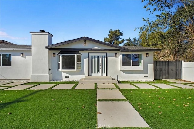 rear view of property featuring a yard