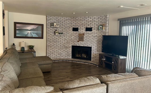 living room with hardwood / wood-style flooring and a fireplace