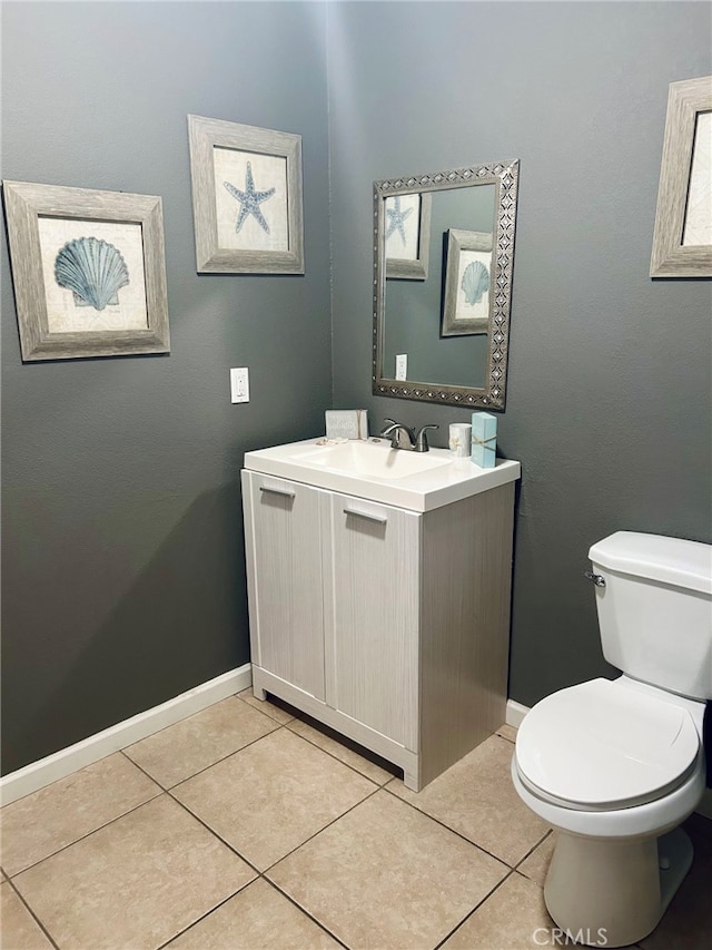 bathroom with vanity, toilet, and tile patterned flooring