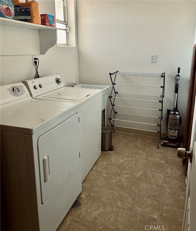 laundry room featuring washing machine and dryer and sink