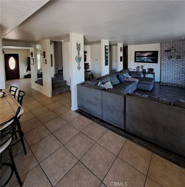 tiled living room featuring a textured ceiling