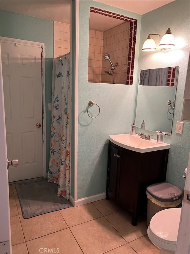 bathroom featuring a shower with curtain, vanity, and tile patterned flooring