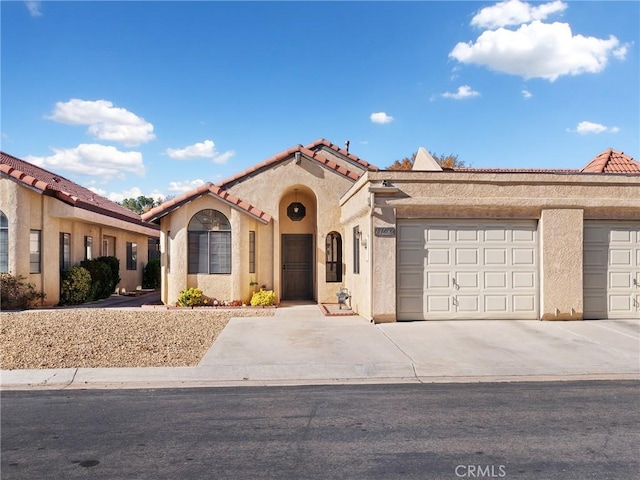 mediterranean / spanish-style house with a garage