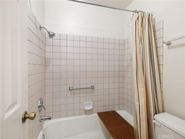 bathroom with shower / tub combo with curtain and toilet