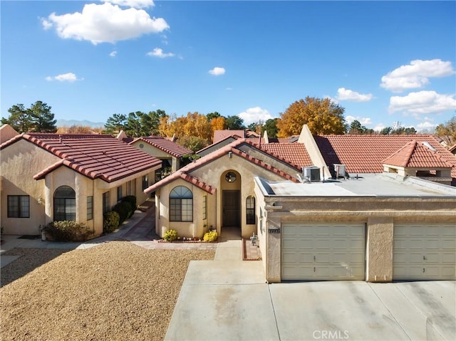 mediterranean / spanish-style home featuring a garage