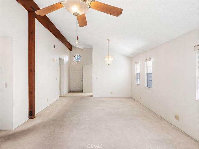 carpeted spare room featuring ceiling fan with notable chandelier, beam ceiling, and high vaulted ceiling