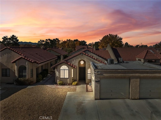 mediterranean / spanish-style home featuring a garage