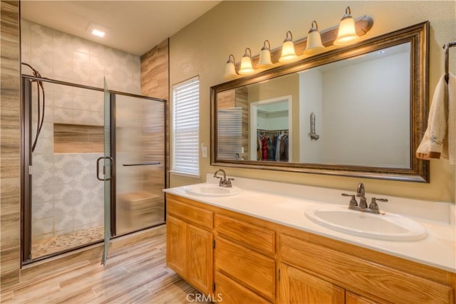 bathroom featuring hardwood / wood-style floors, vanity, and an enclosed shower