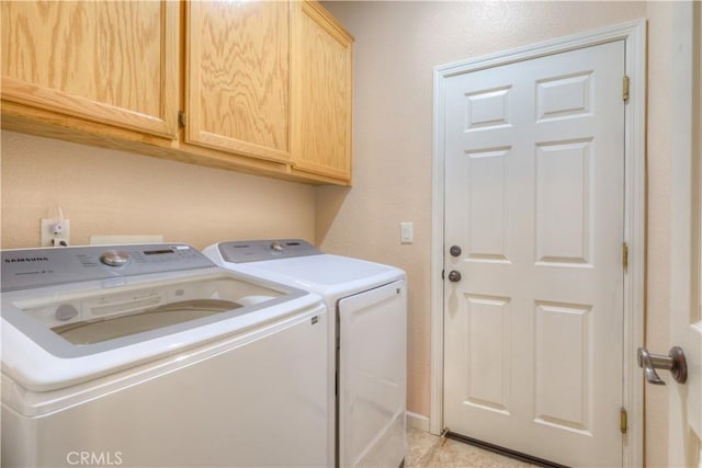 laundry room featuring cabinets and separate washer and dryer