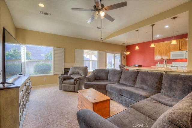 living room with light colored carpet and ceiling fan