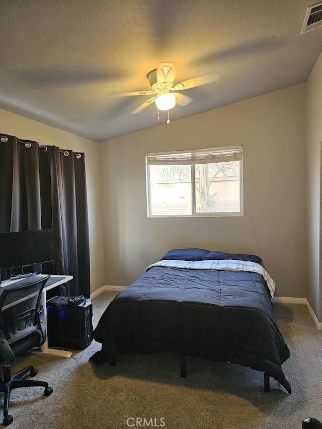 bedroom with a textured ceiling, ceiling fan, carpet, and lofted ceiling