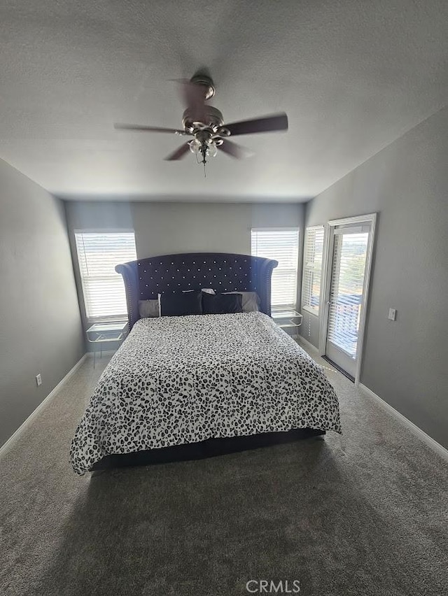 carpeted bedroom with a textured ceiling, access to outside, and ceiling fan