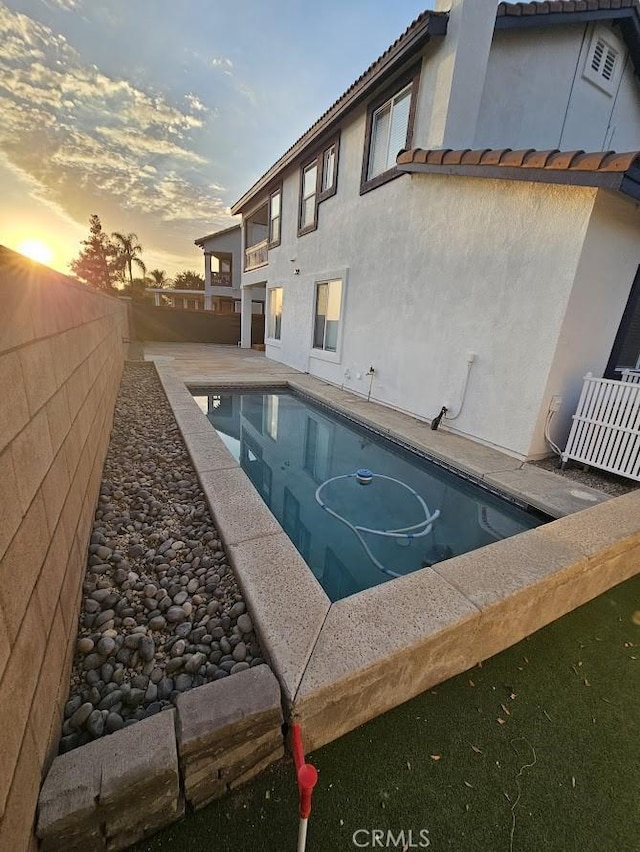 view of pool at dusk