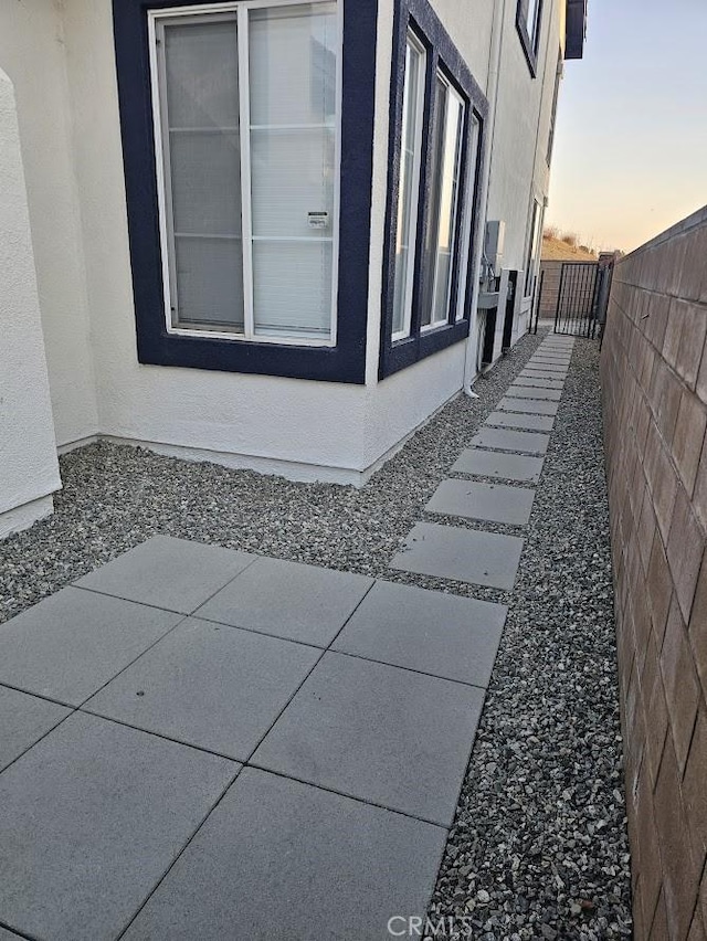 property exterior at dusk with a patio