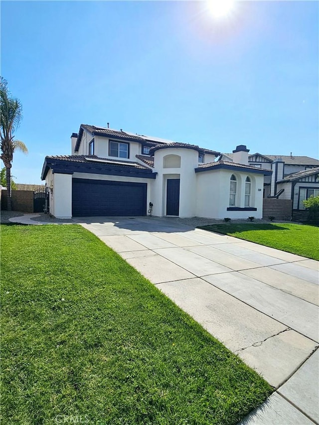 view of front facade featuring a garage and a front lawn