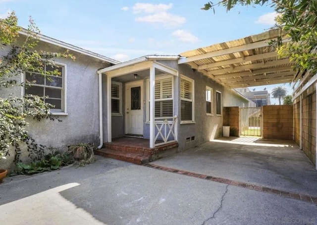 doorway to property with a carport