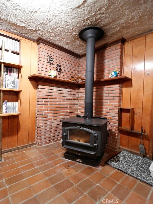 interior details featuring a wood stove and wooden walls