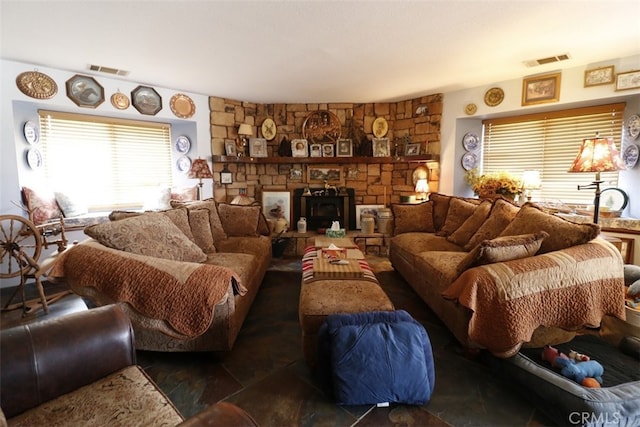 living room with a stone fireplace