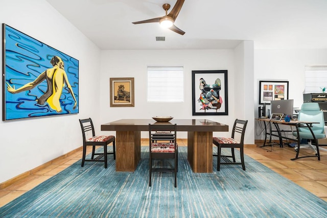 tiled dining space featuring ceiling fan