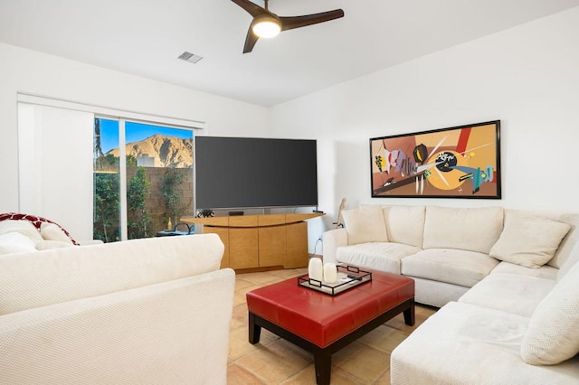 tiled living room featuring ceiling fan