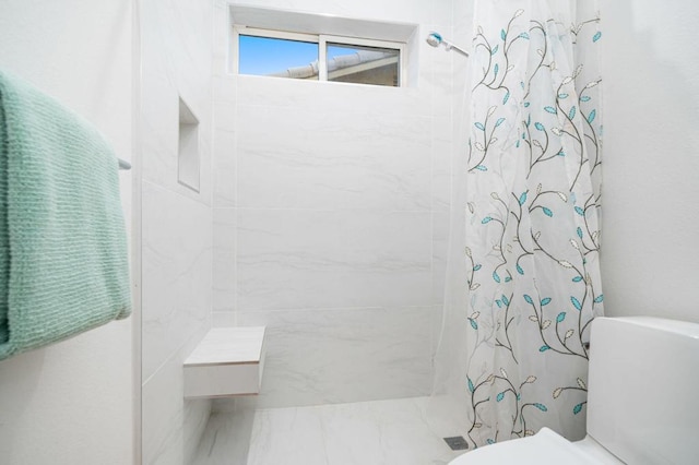 bathroom featuring a shower with curtain and toilet