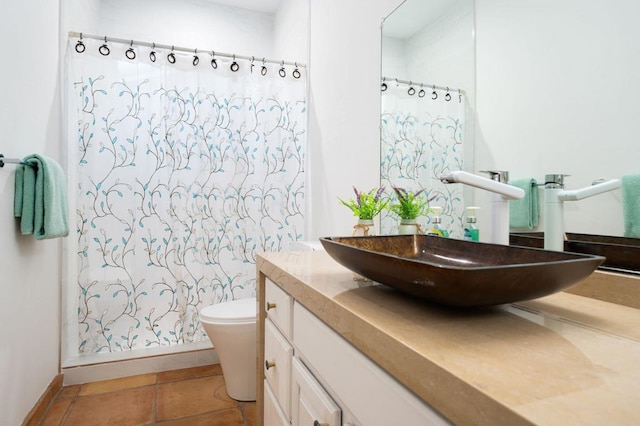 bathroom featuring a shower with curtain, tile patterned floors, and toilet