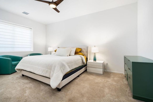 bedroom featuring ceiling fan and light carpet