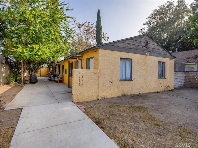 view of side of property featuring a patio area