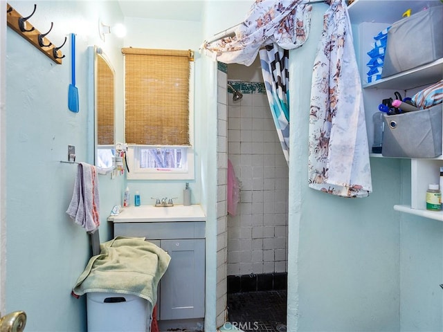 bathroom featuring a shower with curtain and vanity