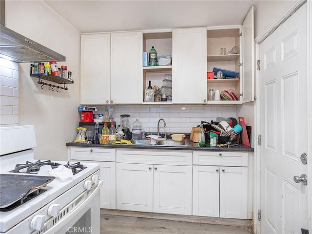 kitchen with light wood-type flooring, white cabinetry, extractor fan, and gas range gas stove