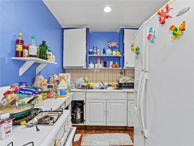 kitchen with white cabinets, white appliances, tasteful backsplash, and sink