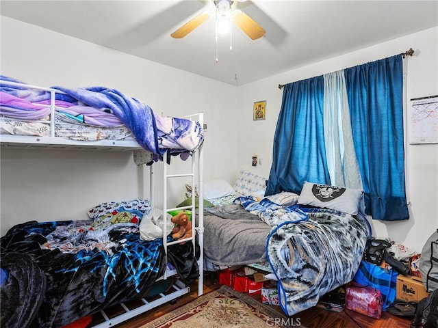 bedroom with ceiling fan and wood-type flooring