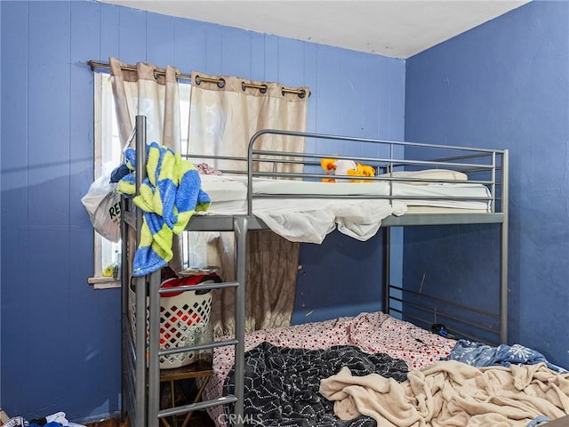 bedroom with wood walls