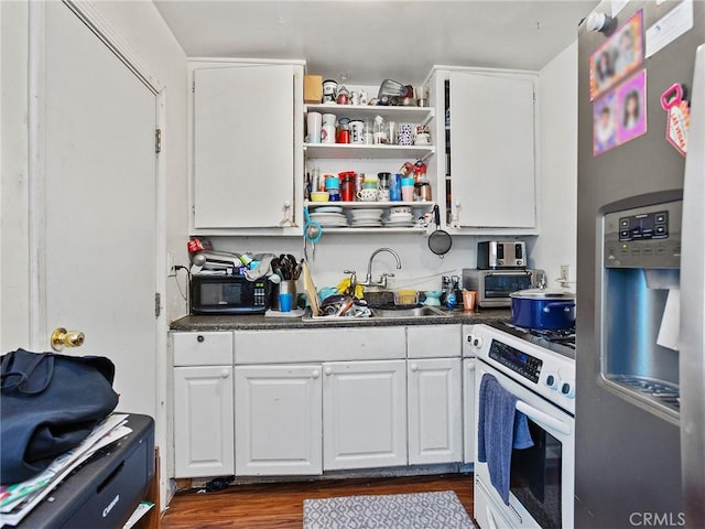 kitchen with wall oven, white cabinets, dark wood-type flooring, and stainless steel refrigerator with ice dispenser