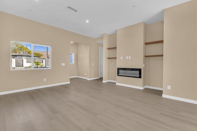 unfurnished living room with hardwood / wood-style flooring