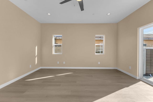 empty room featuring hardwood / wood-style flooring and ceiling fan