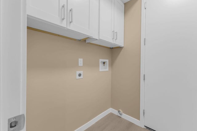 laundry area with hookup for an electric dryer, cabinets, and hookup for a washing machine