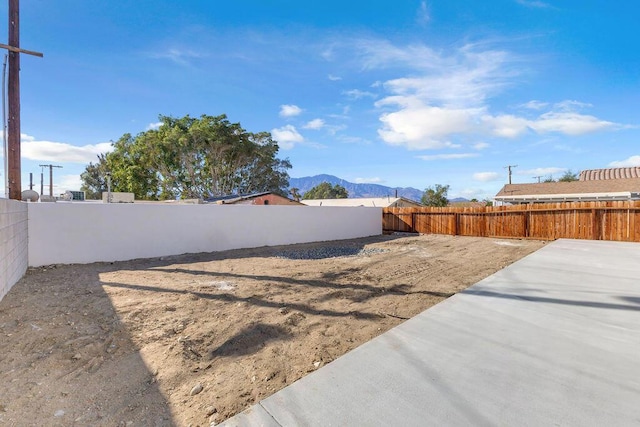 view of yard with a mountain view and a patio