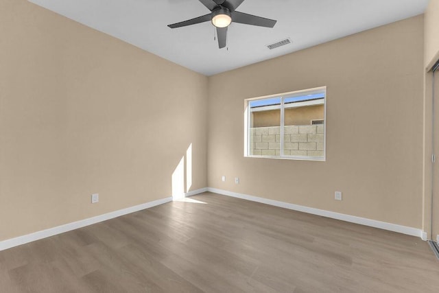 empty room featuring light wood-type flooring and ceiling fan