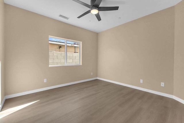 spare room featuring hardwood / wood-style floors and ceiling fan